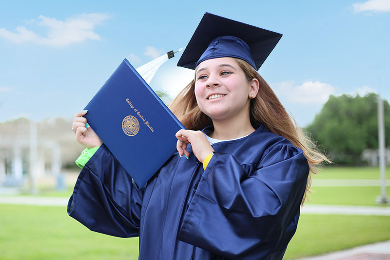 Happy woman smiling with her diploma after graduation