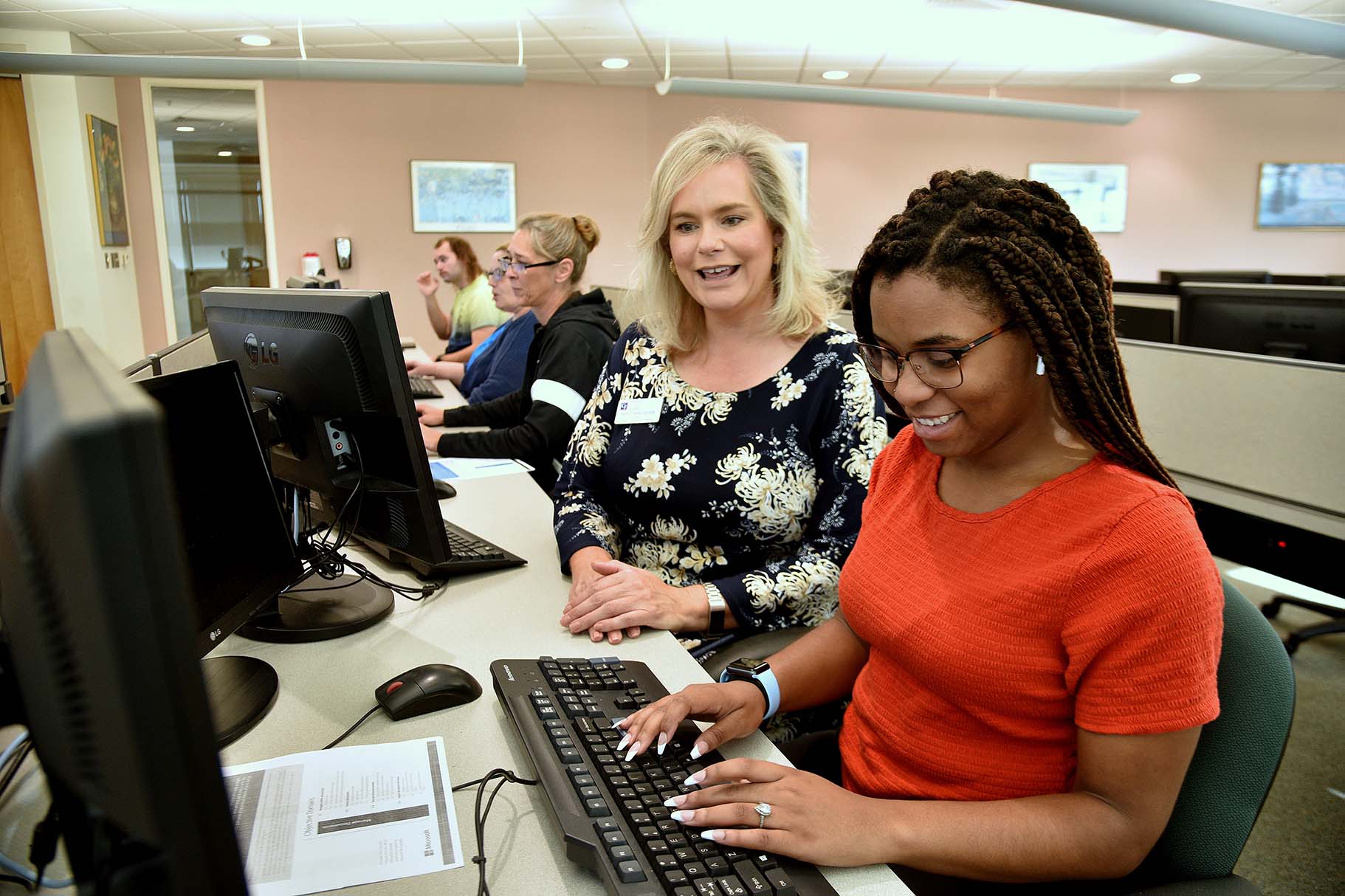 Student and teacher on computer