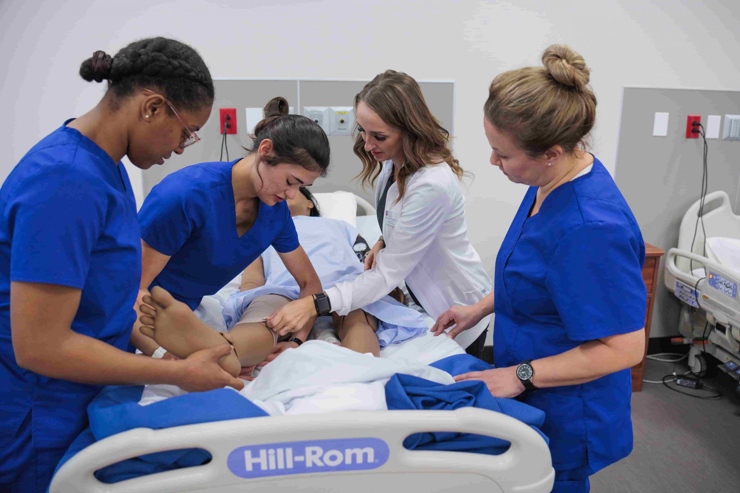 nurses practicing around fake patient