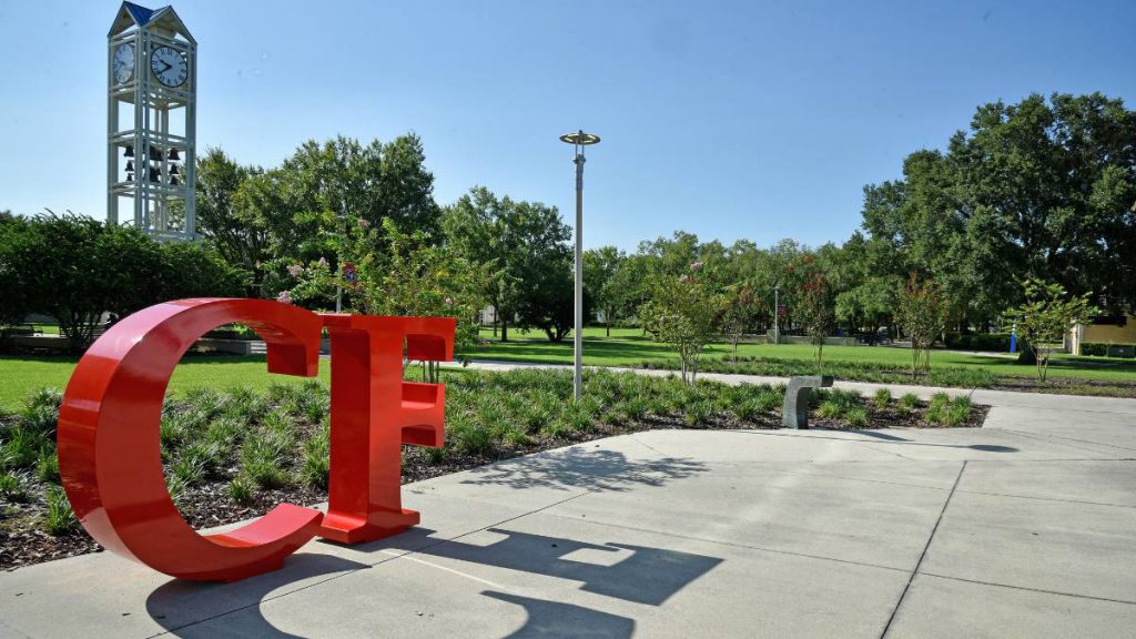 Large red CF letters near a clocktower